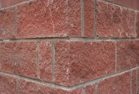 corner of rough red blocks background