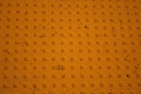 yellow dimpled concrete backgroundの写真素材