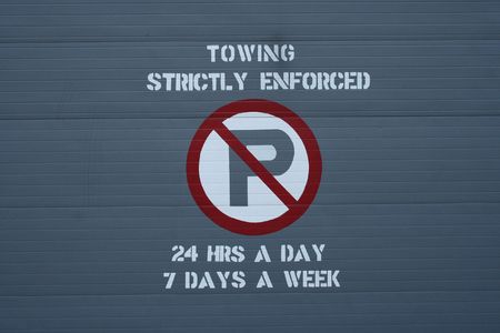 towing strictly enforced sign on garage doorの写真素材