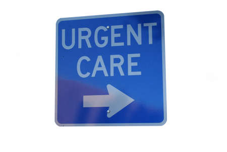 urgent care sign with arrow isolated on blueの写真素材