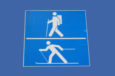 skiing and hiking symbols white figures on blue backgroundの写真素材