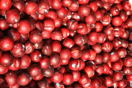 fresh red plums at an outdoor market stallの写真素材