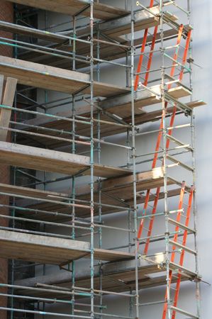 Ladders at construction site with scaffolding