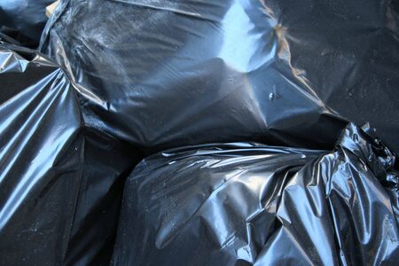 black plastic bag full of garbage background