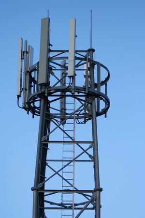 Mobile phone mast against blue sky