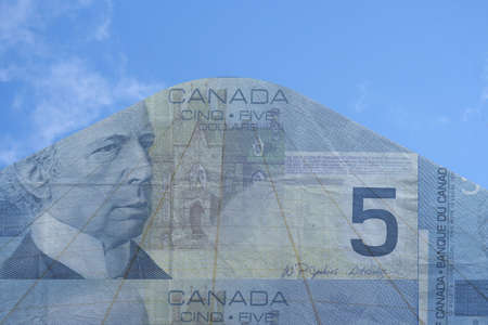 skyscraper and Canadian five dollar billの写真素材