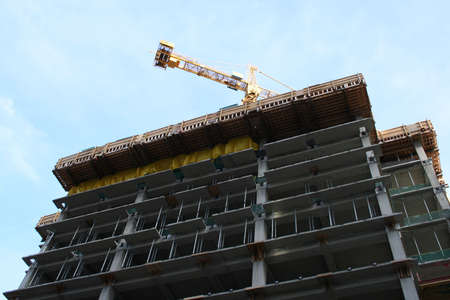 skyscraper under construction with crane