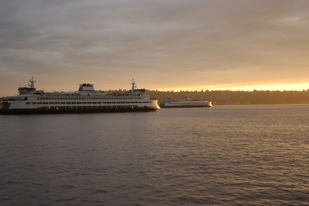 Ferries passing in Puget Sound at sunsetの写真素材