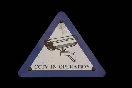 cctv camera warning sign isolated on blackの写真素材