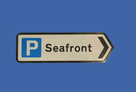 Parking at seafront sign isolated on blueの写真素材