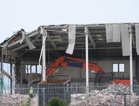 building under demolition with heavy machineryの写真素材