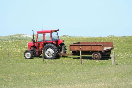 tractor and trailer on farm land