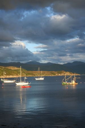 assorted boats on Loch Broom with overcast sky from Ullapool Scotlandの写真素材