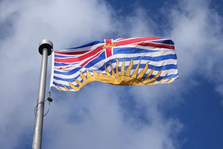 Flag of British Columbia against blue skyの写真素材