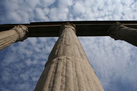Ancient stone colonnade against blue sky Milan Italy