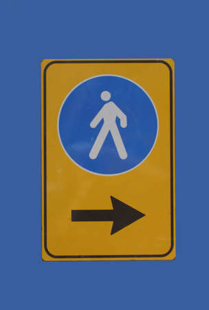 Pedestrians this way sign with arrow on blueの写真素材