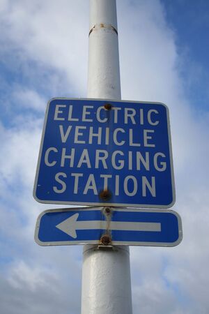 electric vehicle charging station sign with arrowの写真素材