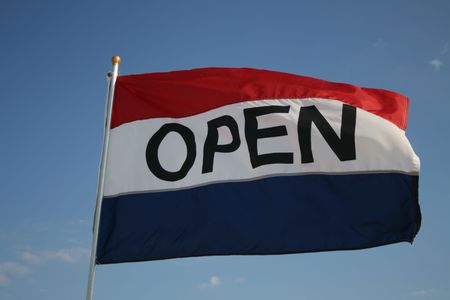 open flag against blue sky