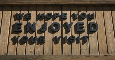 We hope you enjoyed your visit sign on wooden backgroundの写真素材