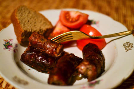homemade sausages with tomatoes and breadの写真素材