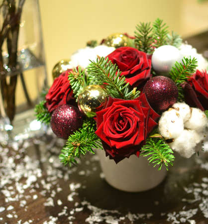 Christmas bouquet with roses, fir, Christmas tree balls and artificial snowの写真素材