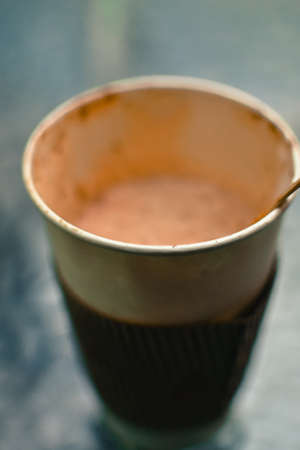 Blurred paper cup of coffee on the table backgroundの写真素材