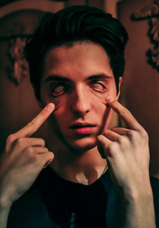Frightening halloween zombie guy with white eyesの写真素材