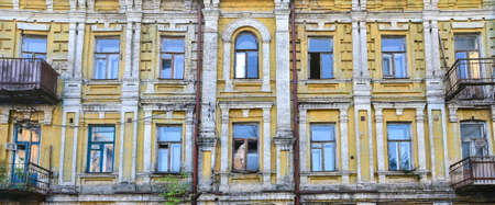 Exterior of old deserted building with broken windows and balconiesの写真素材