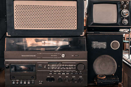 Old vintage audio system with radio, cassette tape recorder, record player, TV set, acoustic speakersの写真素材