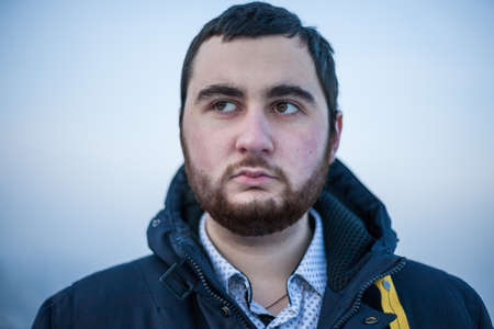 Portrait of a young thoughtful worried manの写真素材