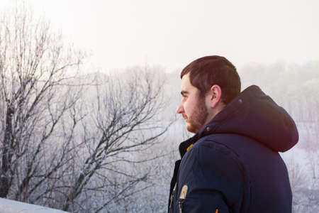 Hipster man traveler against winter landscapeの写真素材