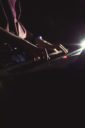 Playing on synthesizer keyboardの写真素材