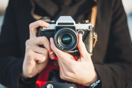 Hipster man photographer taking photo with retro cameraの写真素材