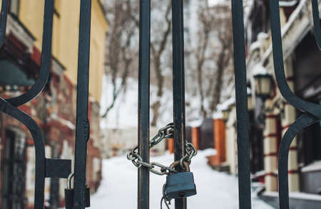 Lock and chain on gates and private residence on backgroundの写真素材
