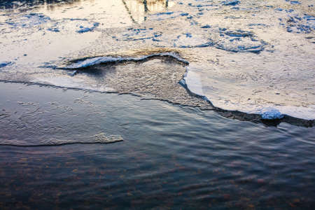 Frozen river surface covered with melting iceの写真素材