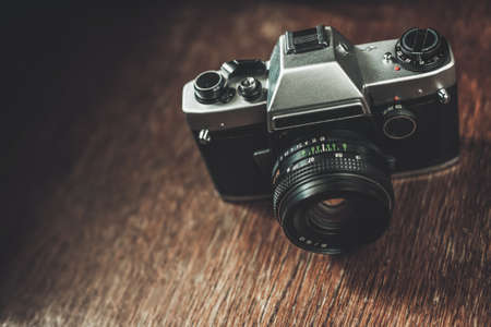 Old retro camera on wooden tableの写真素材