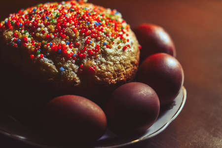 Easter cake and painted eggs on wooden tableの写真素材