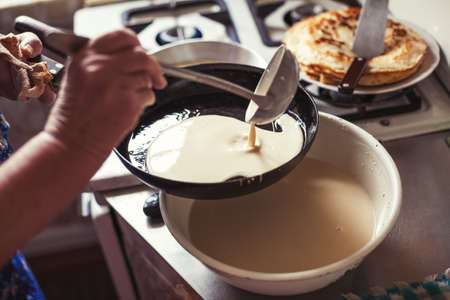 Grandmother making pancakesの写真素材