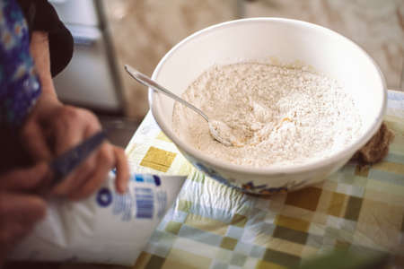 Grandmother preparing batter for pancakesの写真素材