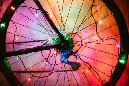 Bicycle wheel decorated with Christmas lightsの写真素材