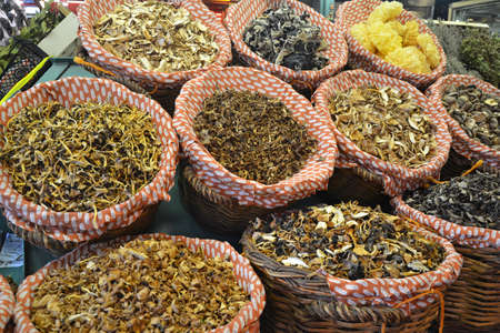 baskets of dried mushrooms for sale at marketの写真素材