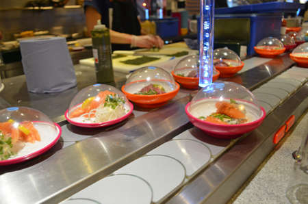 food on a conveyor belt sushi bar restaurantの写真素材