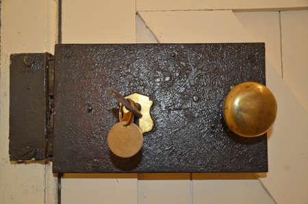 old fashioned door lock with brass door knobの写真素材