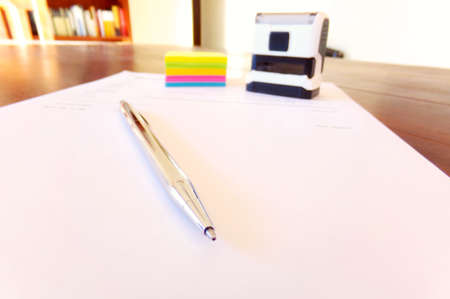 Signature and sealing of a contract printed on the desk.
