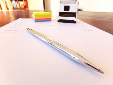 Signature and sealing of a contract printed on the desk.