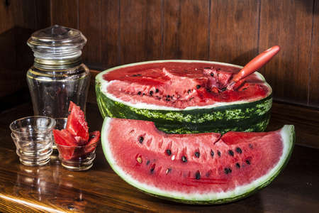 Watermelon cut into slices on a wooden mobileの写真素材