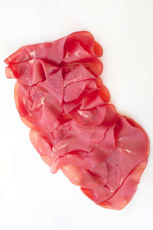 Slices of dried beef on white backgroundの写真素材
