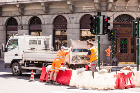 Men at work in the middle of an intersection of a city.のeditorial素材