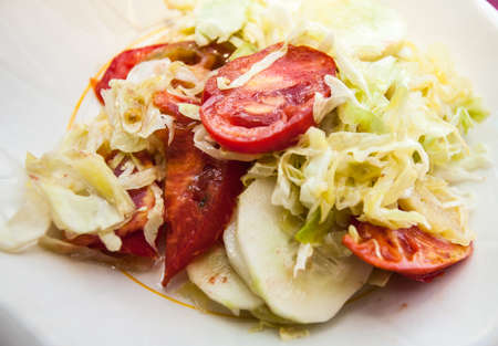 Fresh and healthy salad on a white plate outdoors.の写真素材
