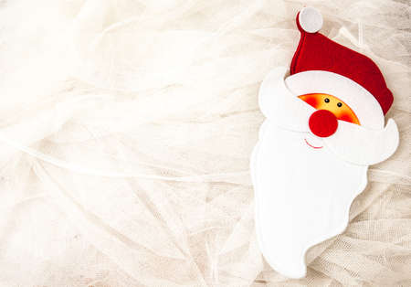 Cheerful Santa Claus face on tulle white, suitable for greeting card or backgroundの写真素材